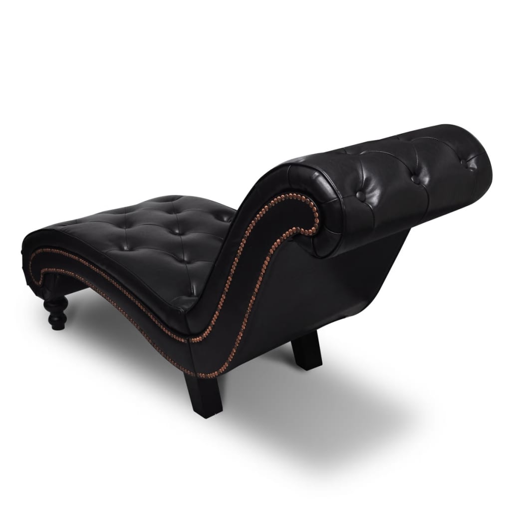 Rear angled view of the curved chaise showing its rolled back, dark upholstery, and nailhead edging.