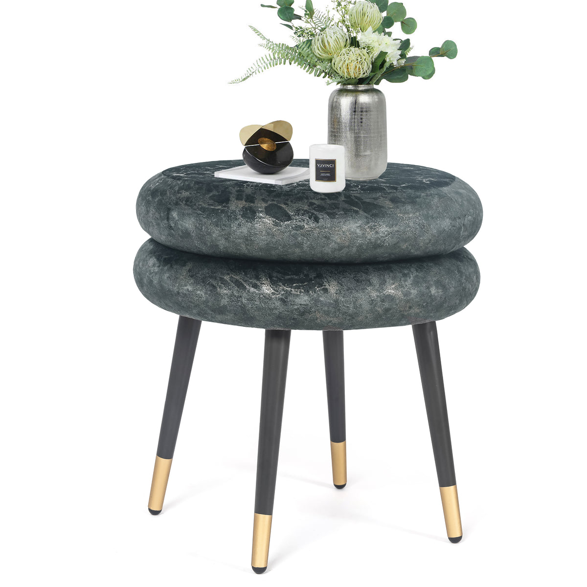 Round velvet ottoman styled with flowers and accessories