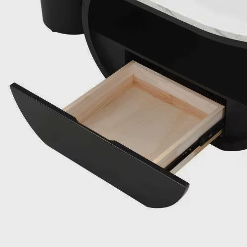 Close-up of the coffee table's open drawer with a black front