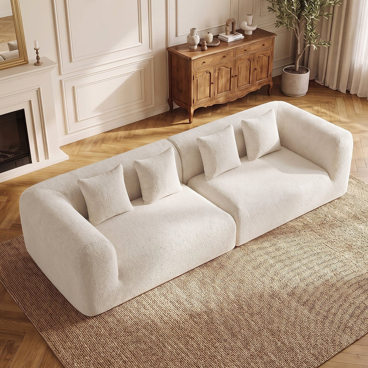 Curved Chenille Modular Sofa in Beige, viewed from above with four coordinating pillows.