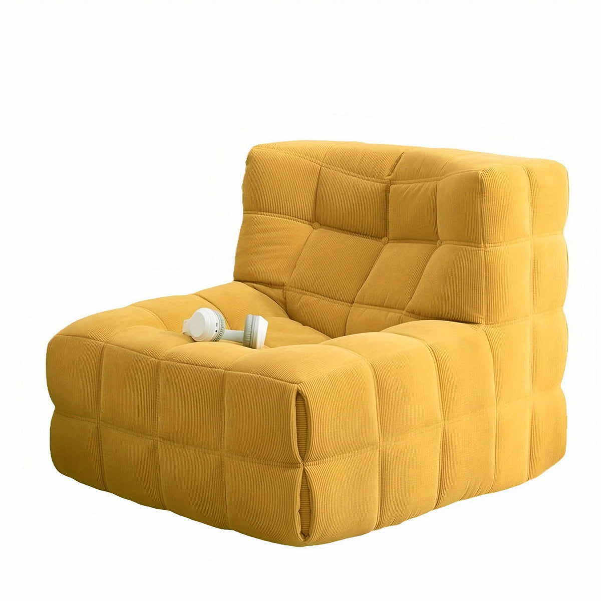 Mustard yellow padded floor lounge chair with square tufting and broad arms