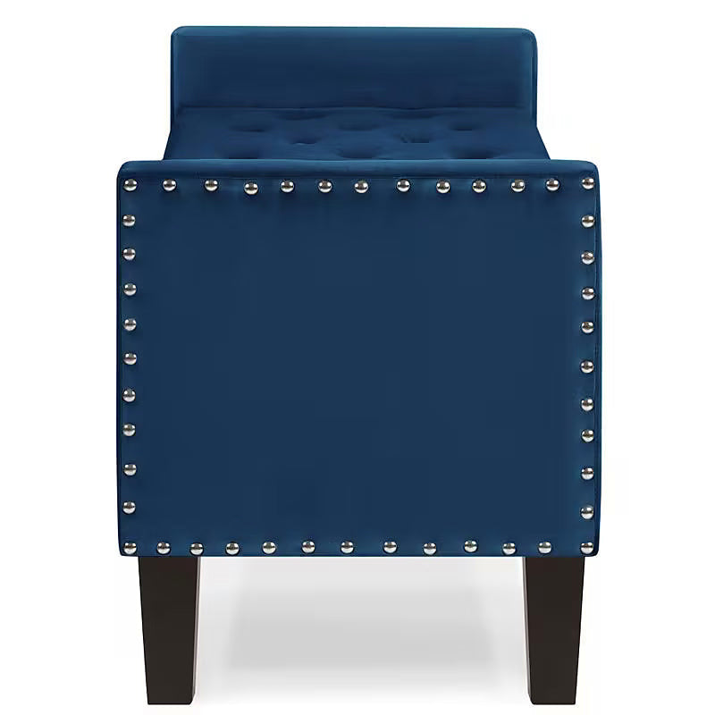 End view of the navy storage bench with a low arm and nailhead trim