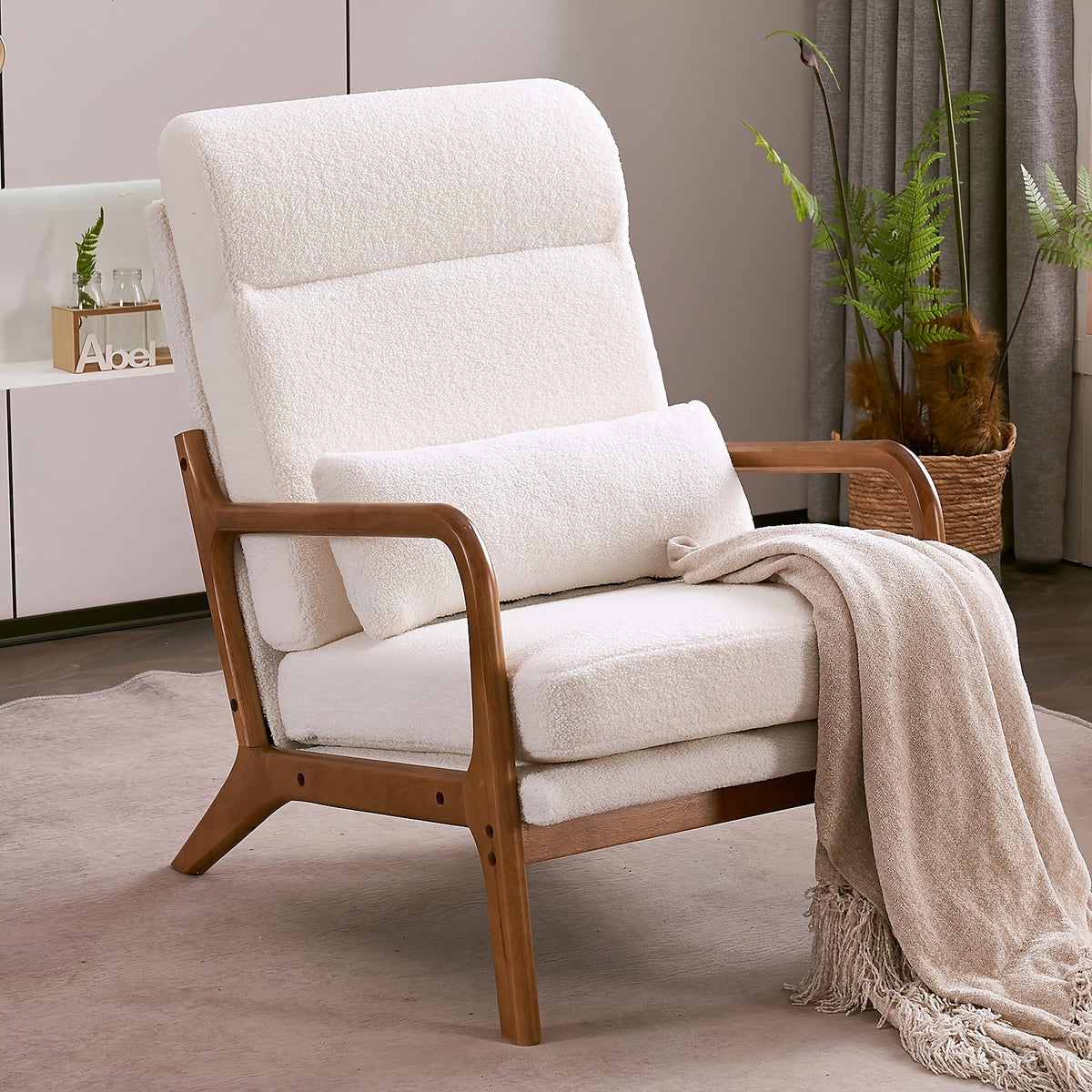 White high back upholstered lounge chair with a warm wood frame