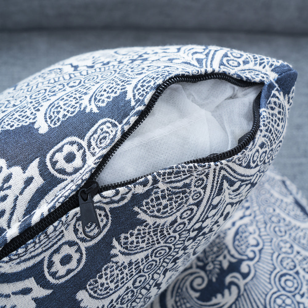 Blue-Grey Curved Sofa with Damask Pillows — damask pillow zipper detail.