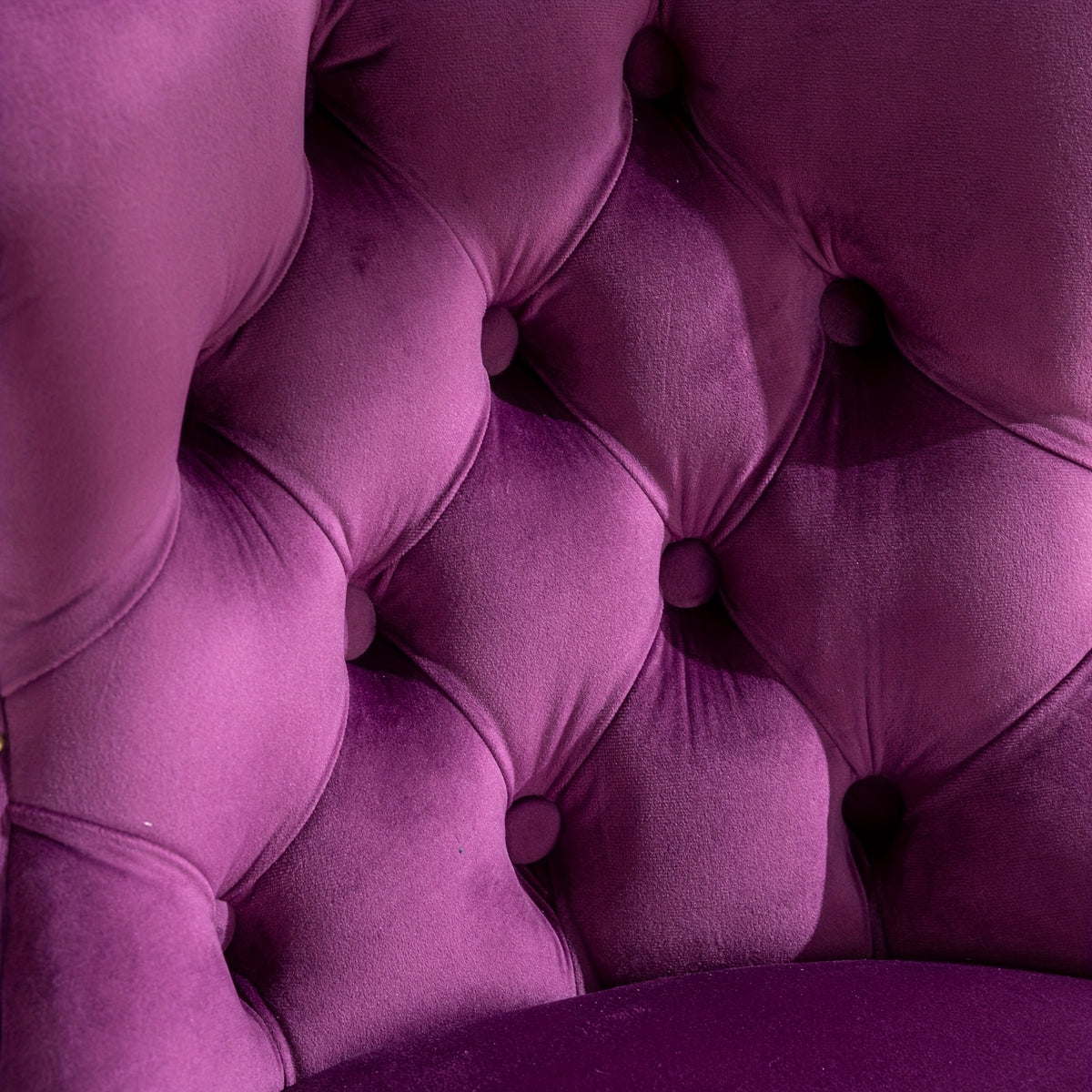 Close-up of button tufting on the purple velvet stool back