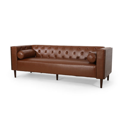 Cognac Button-Tufted Sofa with Bolster Pillows — front three-quarter view.