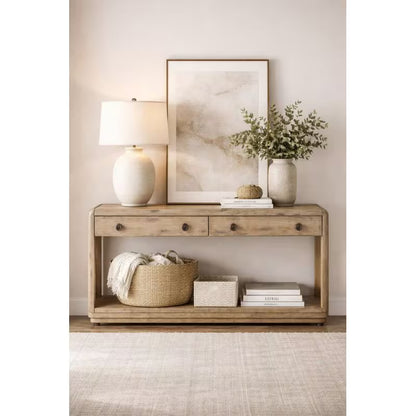 Oak console table styled with a lamp, vase and baskets on the lower shelf
