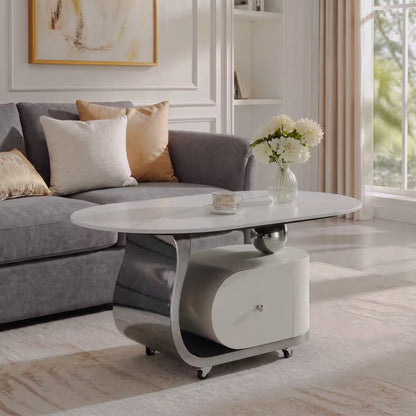 Side view of cream and silver-tone oval coffee table with a curved support and wheeled drawer base