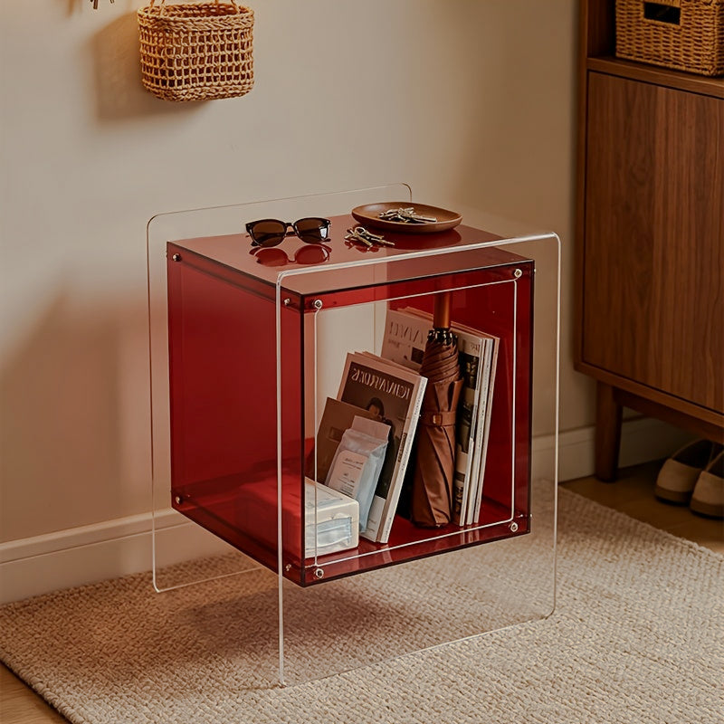 Red acrylic open-cube side table with clear outer supports and magazines inside
