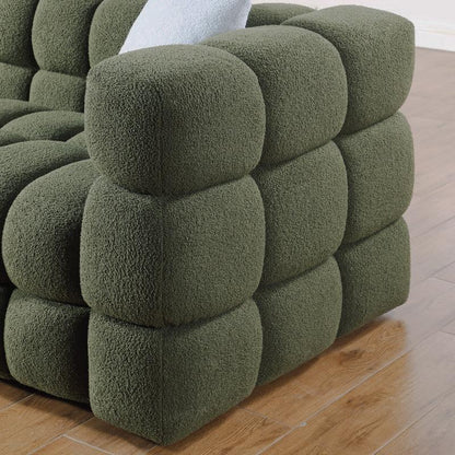 Close-up of the olive green sofa's rounded tufted arm
