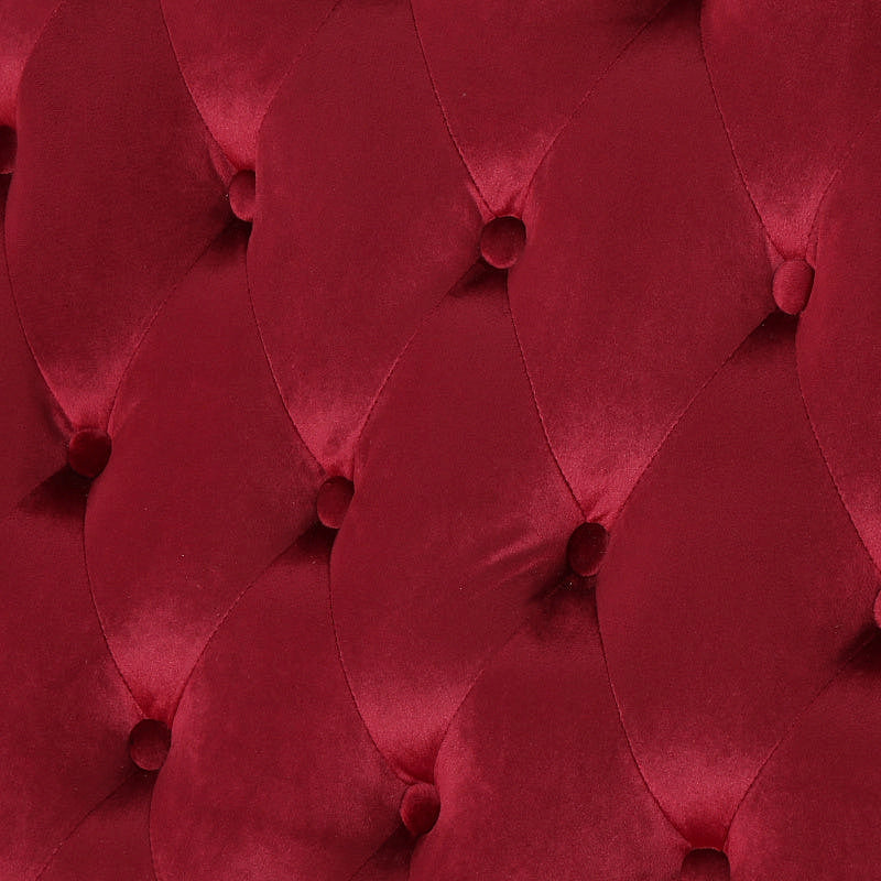 Close-up of the wine red velvet upholstery and diamond button tufting.