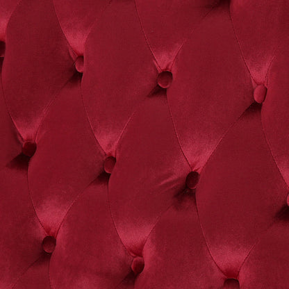 Close-up of the wine red velvet upholstery and diamond button tufting.