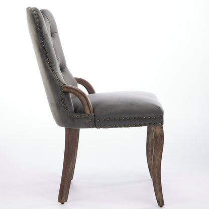 Gray velvet dining chair with a tufted back, wood handle, and curved wood legs