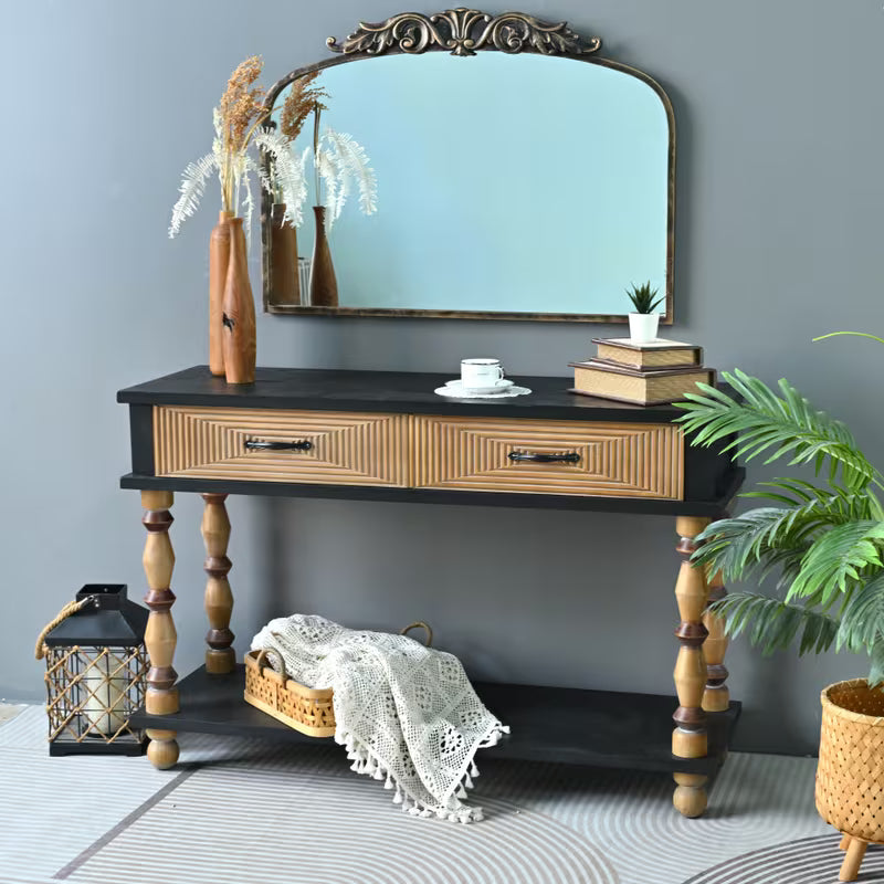 Two-tone console styled with a mirror, books and a basket on its lower shelf.