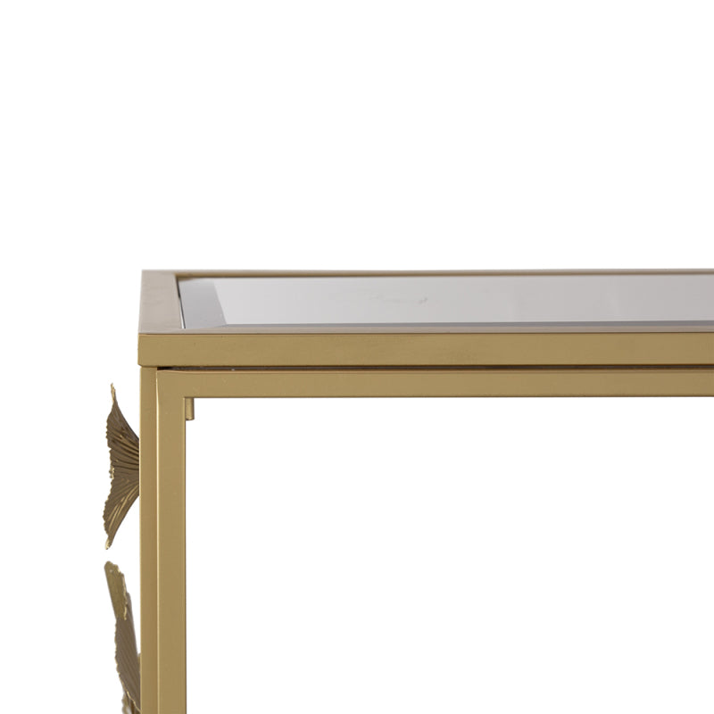 Close-up of the mirrored tabletop edge and gold-tone rectangular frame.
