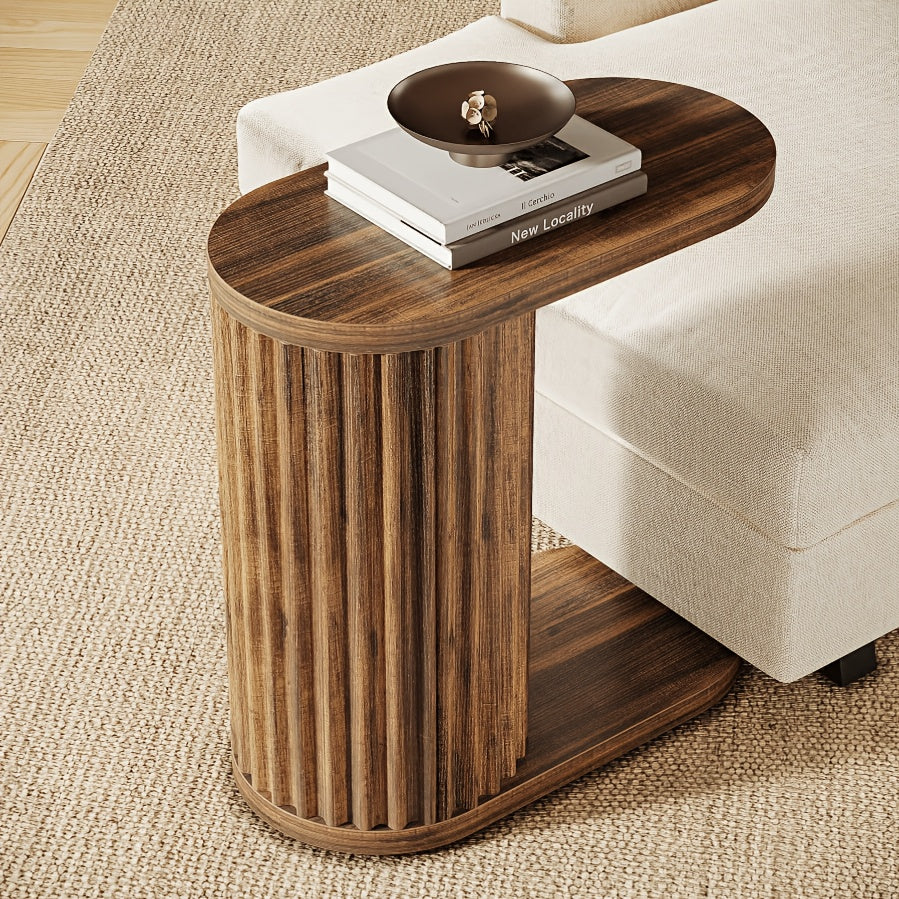Rustic brown C-shaped side table showing its oval top and fluted support.