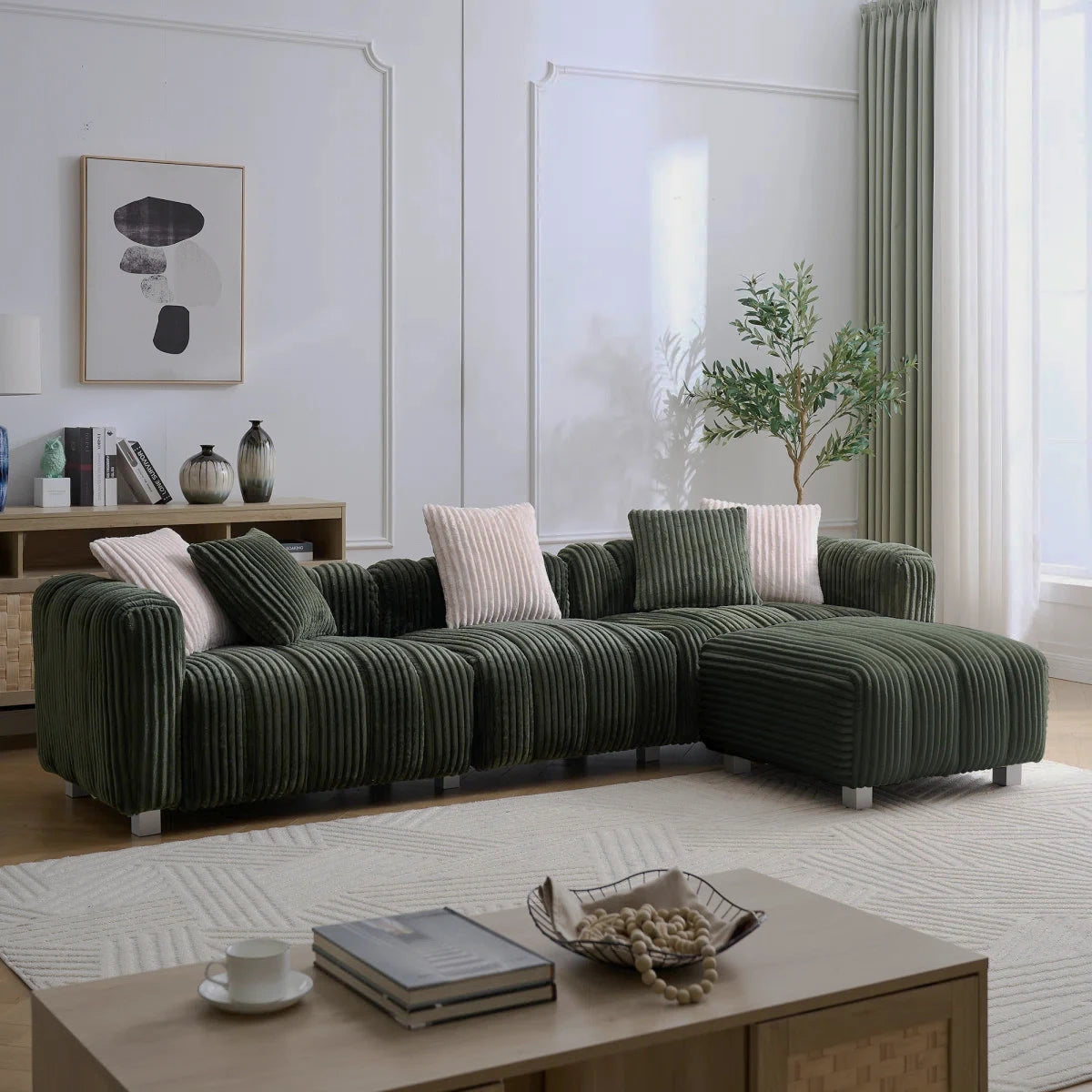 Green ribbed sectional sofa with a matching footrest in a bright living room