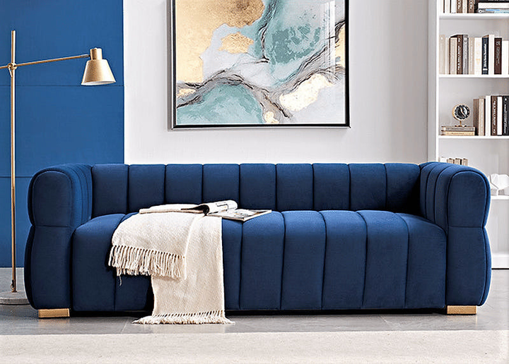Soren blue velvet channel-tufted sofa in a living room