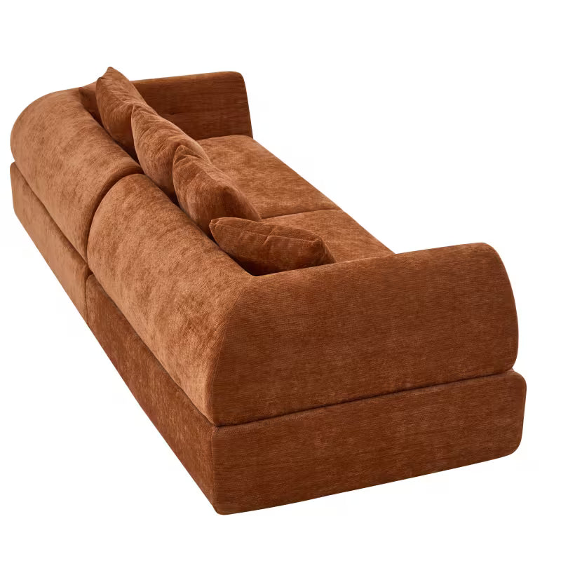 Rear angle of the orange modular sofa showing upholstered back and low base