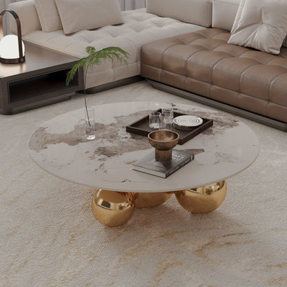 Overhead angled view of the rounded faux-marble top and gold-tone ball base