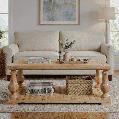 Natural-finish rectangular coffee table with turned legs and a lower shelf beside a cream sofa
