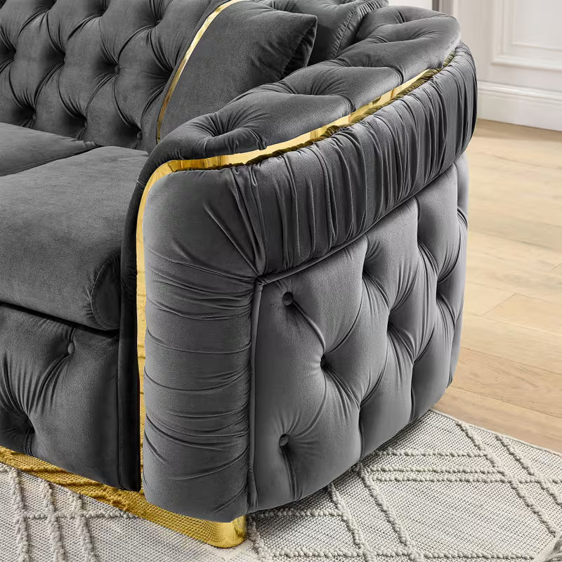 Velvet Chesterfield Sofa with Gold-Tone Trim — tufted arm and gold-tone trim close-up.