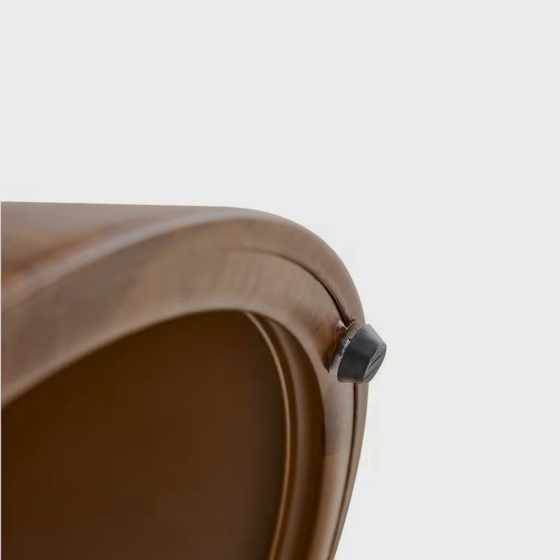 Close-up of the underside edge and dark foot pad on the brown cat-cubby table base