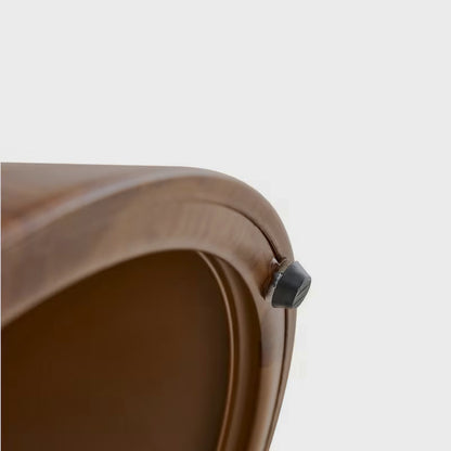 Close-up of the underside edge and dark foot pad on the brown cat-cubby table base