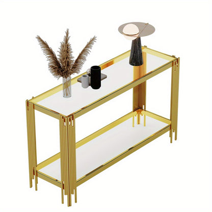Gold reeded-leg console isolated with decor on its reflective top and lower glass shelf