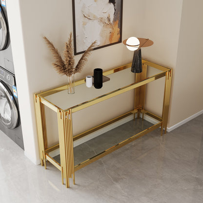 Gold-tone mirrored console with grouped reeded corner legs in a tiled room