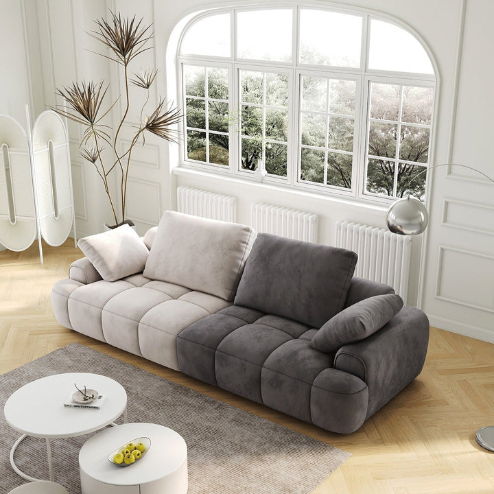 Remy Two-Tone Two-Seat Sofa — three-quarter view in a bright living room
