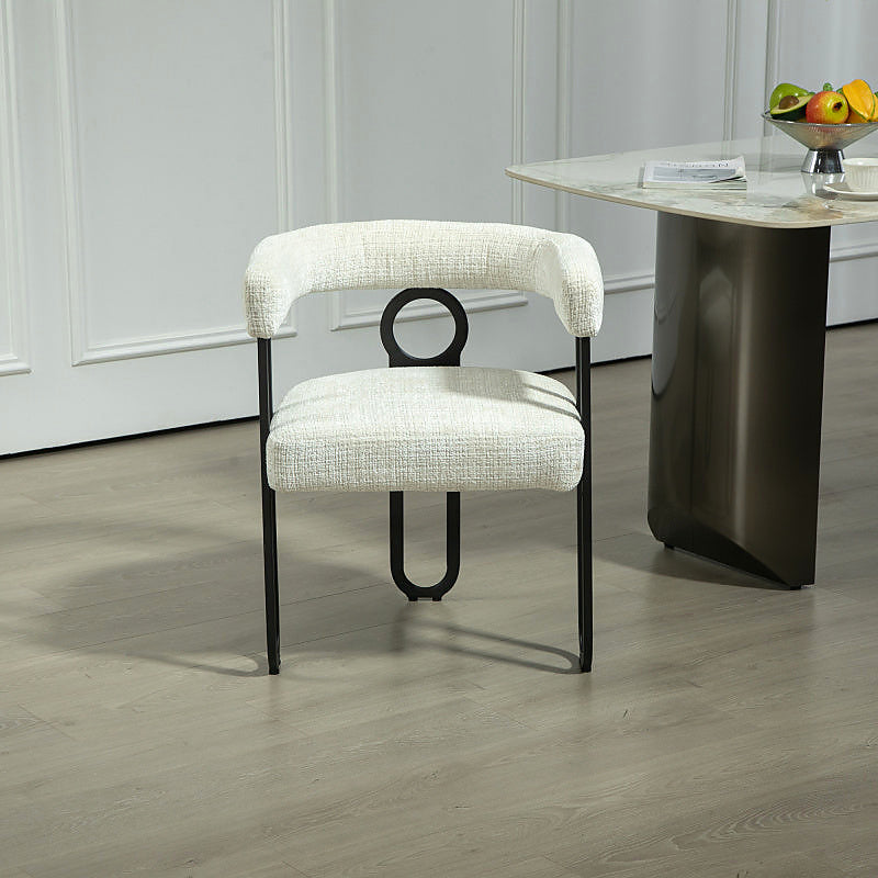 Beige chenille dining chair with a black metal loop frame