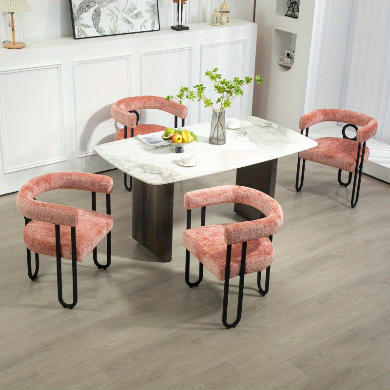 Dining setting with pink chenille chairs; table and additional chairs are styling props