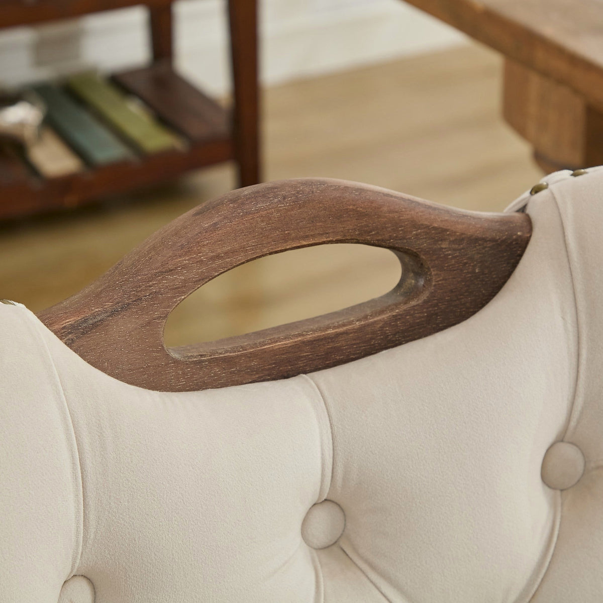 Beige velvet dining chair with a tufted back, wood handle, and curved wood legs