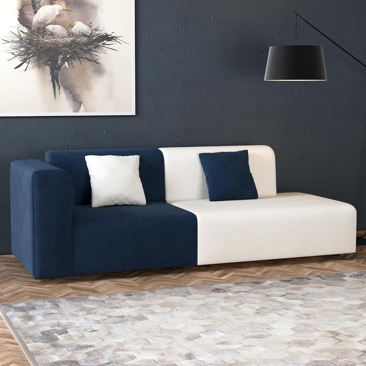 Navy and Ivory Color-Block Sofa — navy and ivory sofa in a dark studio room.