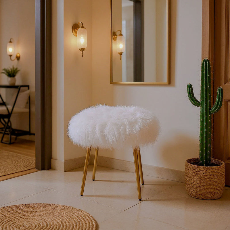 White faux fur stool with gold-tone legs in entryway