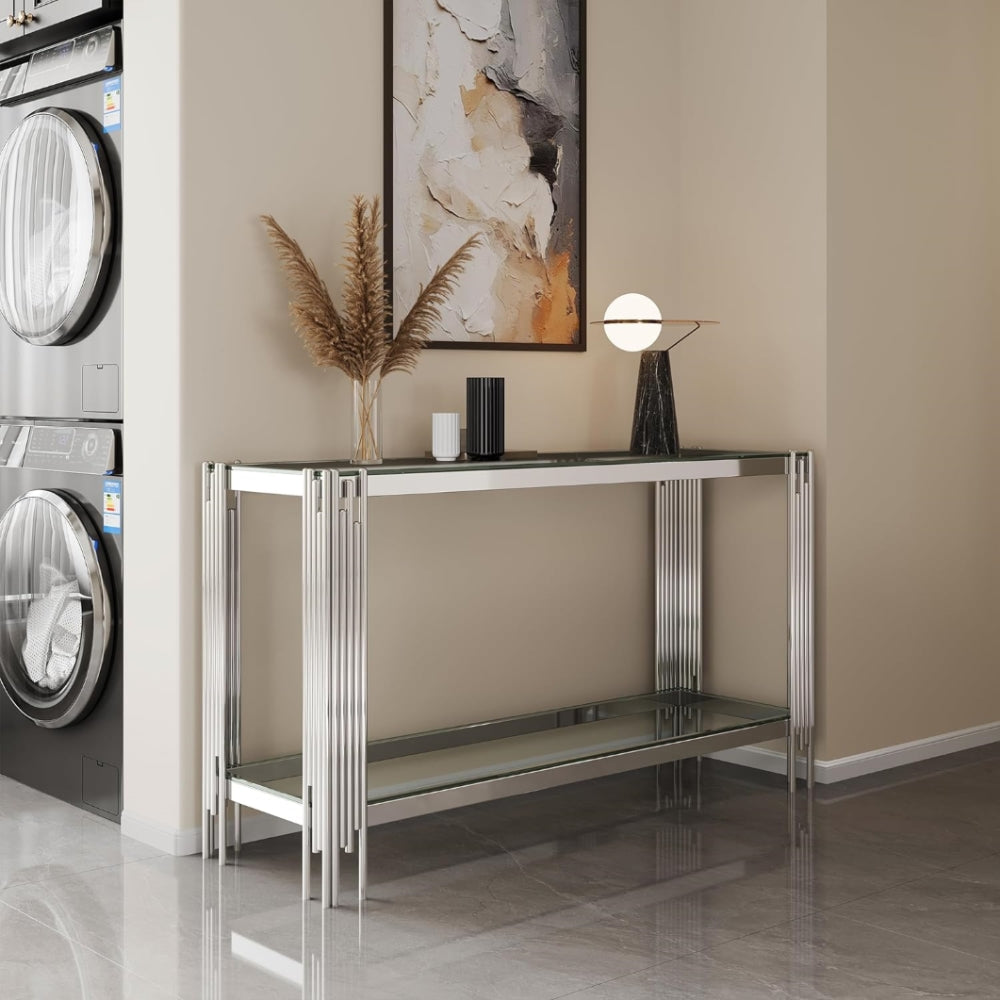 Angled room view of the clear glass and silver frame console.