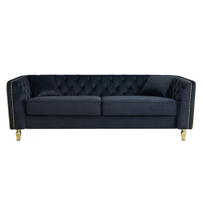 Black tufted sofa with gold-tone piping, straight-on front view