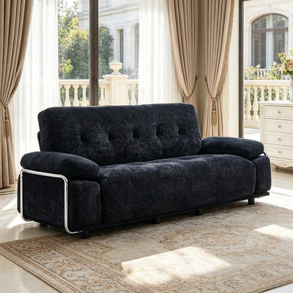 Alden black tufted sofa, angled view of steel armrest frame