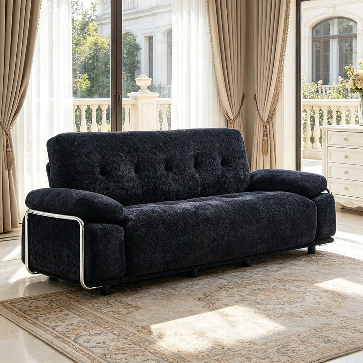 Alden black tufted sofa, angled view of steel armrest frame