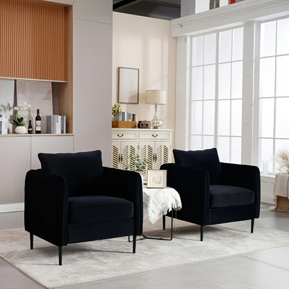 Two black accent armchairs in a bright living room