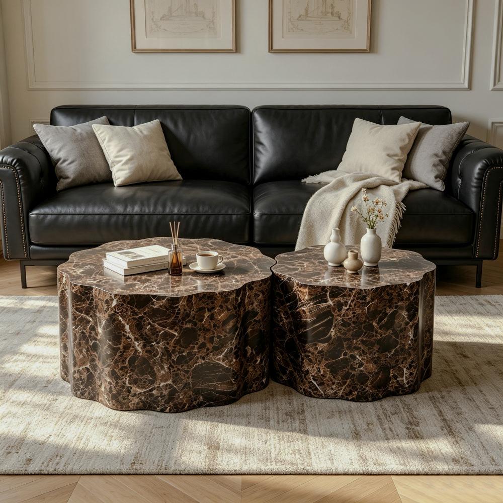Two low round tables with scalloped edges and dark brown marble-patterned surfaces beside a black sofa