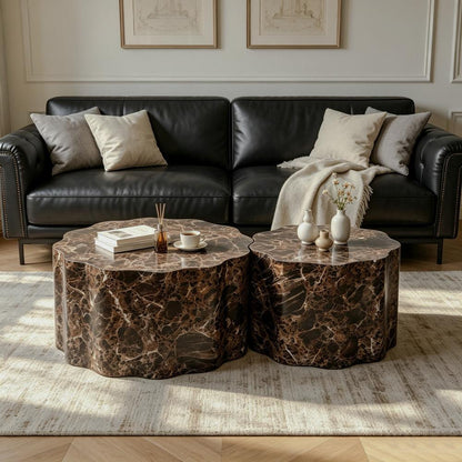 Two low round tables with scalloped edges and dark brown marble-patterned surfaces beside a black sofa
