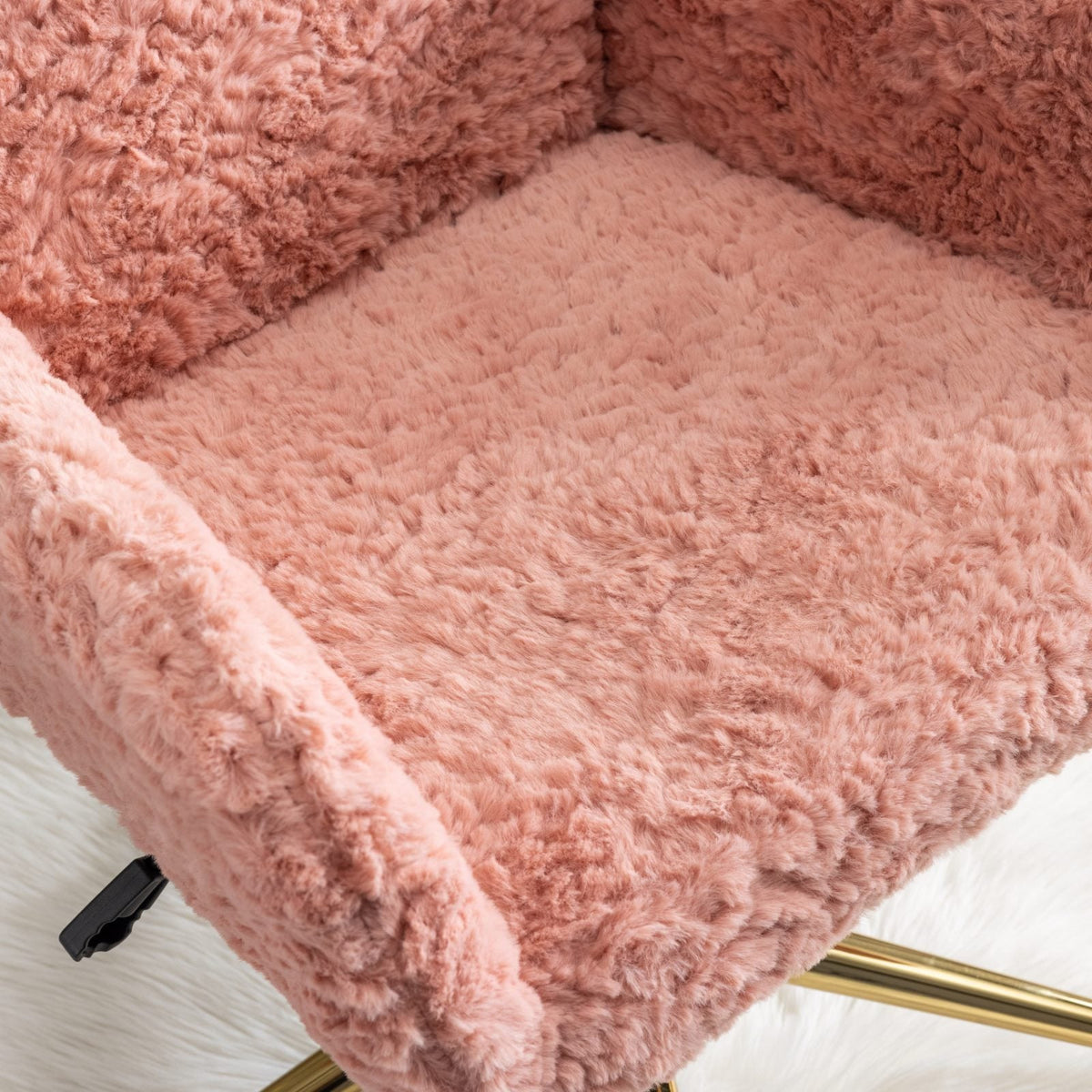 Close-up of the pink chair's plush seat upholstery