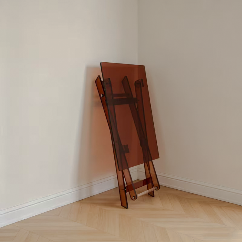 Brown acrylic side table folded and leaning against a wall