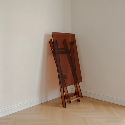 Brown acrylic side table folded and leaning against a wall