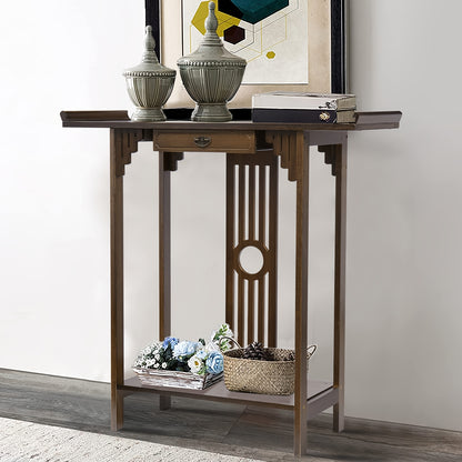 Brown bamboo console styled with books and a vase against a light wall.