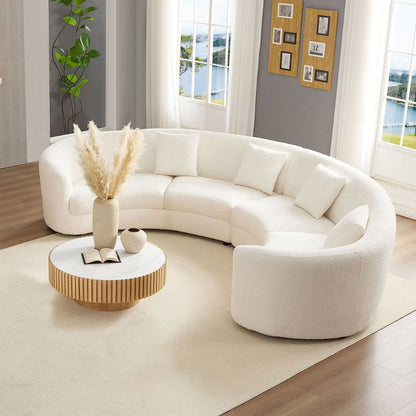 Ivory Curved Sofa with Four Pillows — overhead room view of curved seating.