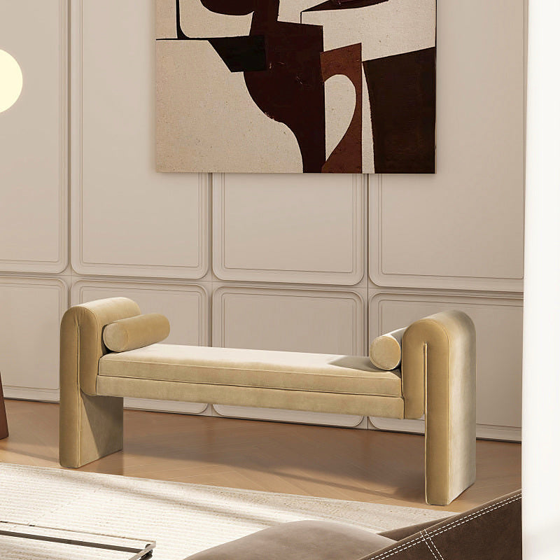 Mason beige upholstered arm bench with two bolster pillows in an indoor sitting area