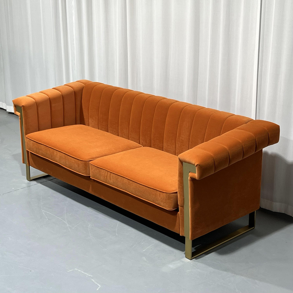 Orange Channel-Tufted Velvet Sofa — three-quarter view showing channel tufting.